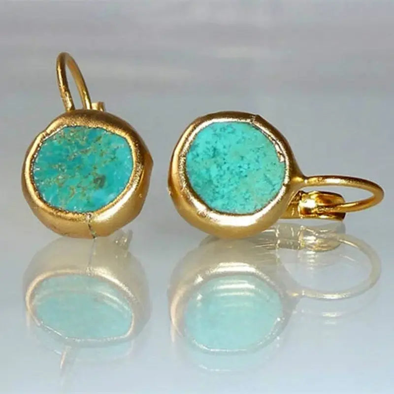 Elegante oorbellen in goud met turquoise steen